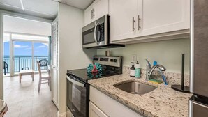 A modern kitchen with stainless steel appliances, a granite countertop, and a view to the outside. - New Penthouse-Oceanfront, Heated Pools, TOP Floor (Myrtle Beach)