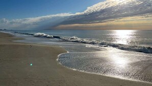 A beach with waves, a clear sky, and the sun. - New Penthouse-Oceanfront, Heated Pools, TOP Floor (Myrtle Beach)