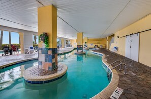 Relax by the pool with lounge chairs and a table nearby.