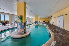 Relax by the pool with lounge chairs and a table nearby.