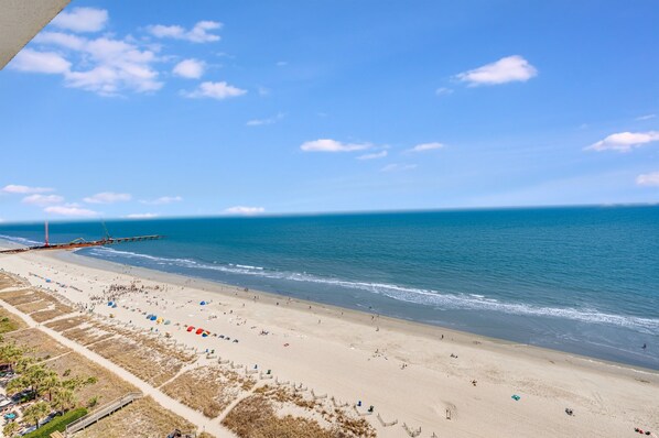 Enjoy a day at the beach with access to a pier and scenic views.