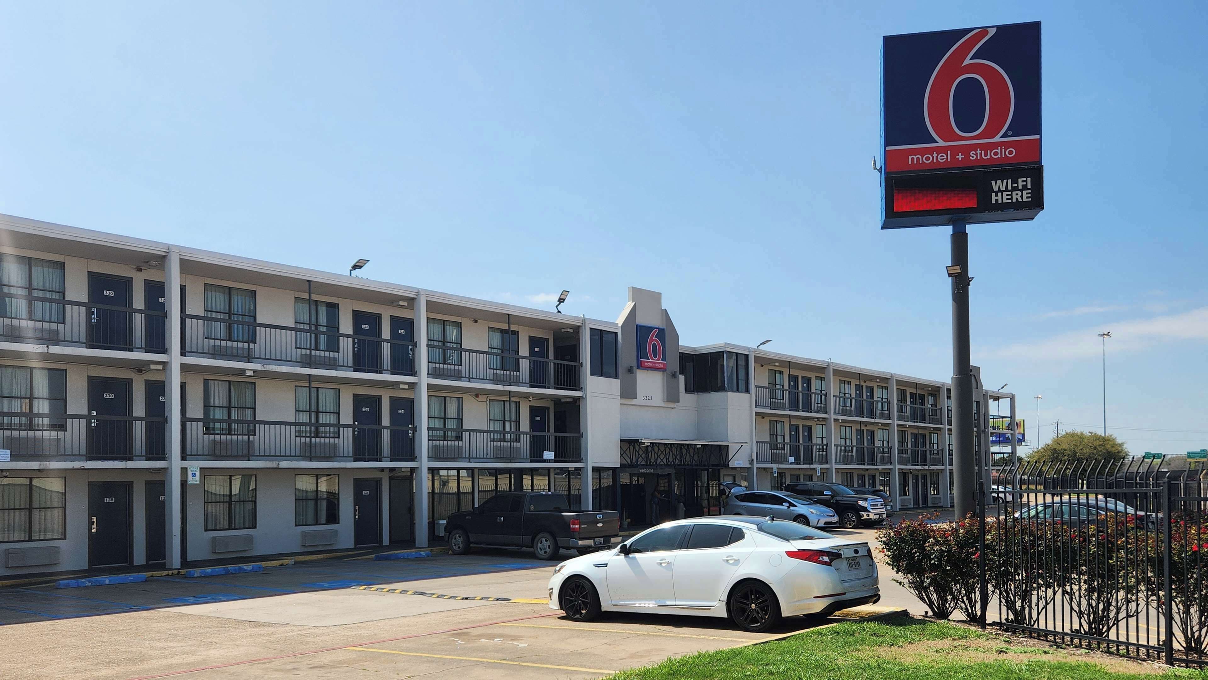 A multi-story motel with a prominent '6' sign, indicating it is part of a chain.