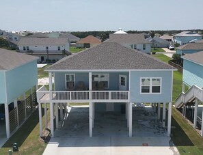 A two-story house with a balcony, a covered porch, and a garage.
