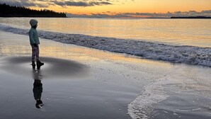 A child standing on a wet beach at sunset. - Fantastic Beach & Ocean Views (Grand Manan)