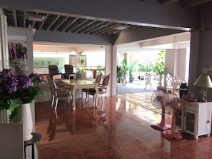 Enjoy meals and work sessions in this room's spacious dining area, featuring a large table and comfortable chairs.
