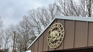 A building with a circular emblem reading "CARDIS LAKE RESORTS" on the side.