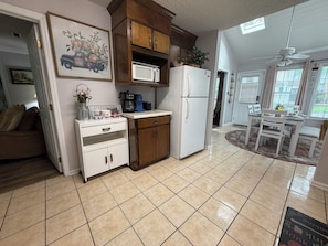 A kitchen with a microwave, refrigerator, and wooden cabinets. - Spacious Peaceful Home 3BR 2BA,Quiet Neighborhood (Valdosta)