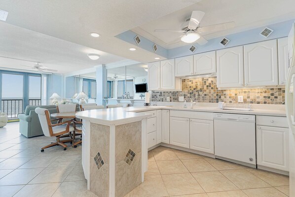 Enjoy cooking in this well-designed kitchen with a central island, ample counter space, and integrated appliances.