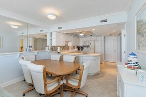 Enjoy cooking in this well-equipped kitchen with a central island, microwave, and oven, perfect for preparing meals.