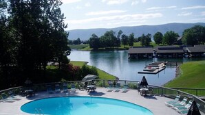 A swimming pool with lounge chairs and a dock, surrounded by a deck and a view of a lake and mountains. - Amazing View, Quiet Cove of Bernards Landing, Sandy Beach, 3 Kings and Twin Bunk (Moneta)