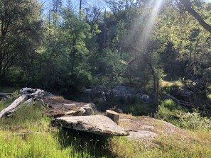 A natural outdoor setting with a forested area, rocks, and a clear sky. - Finegold Escape (North Fork)