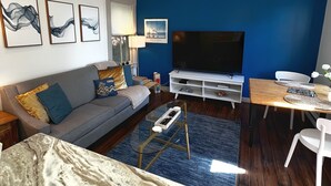 A modern living room with a sofa, coffee table, and TV.