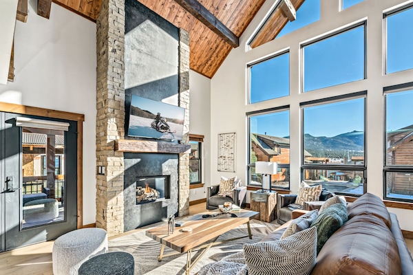 Living room with cozy 25 foot tall fireplace an 50 inch smart TV