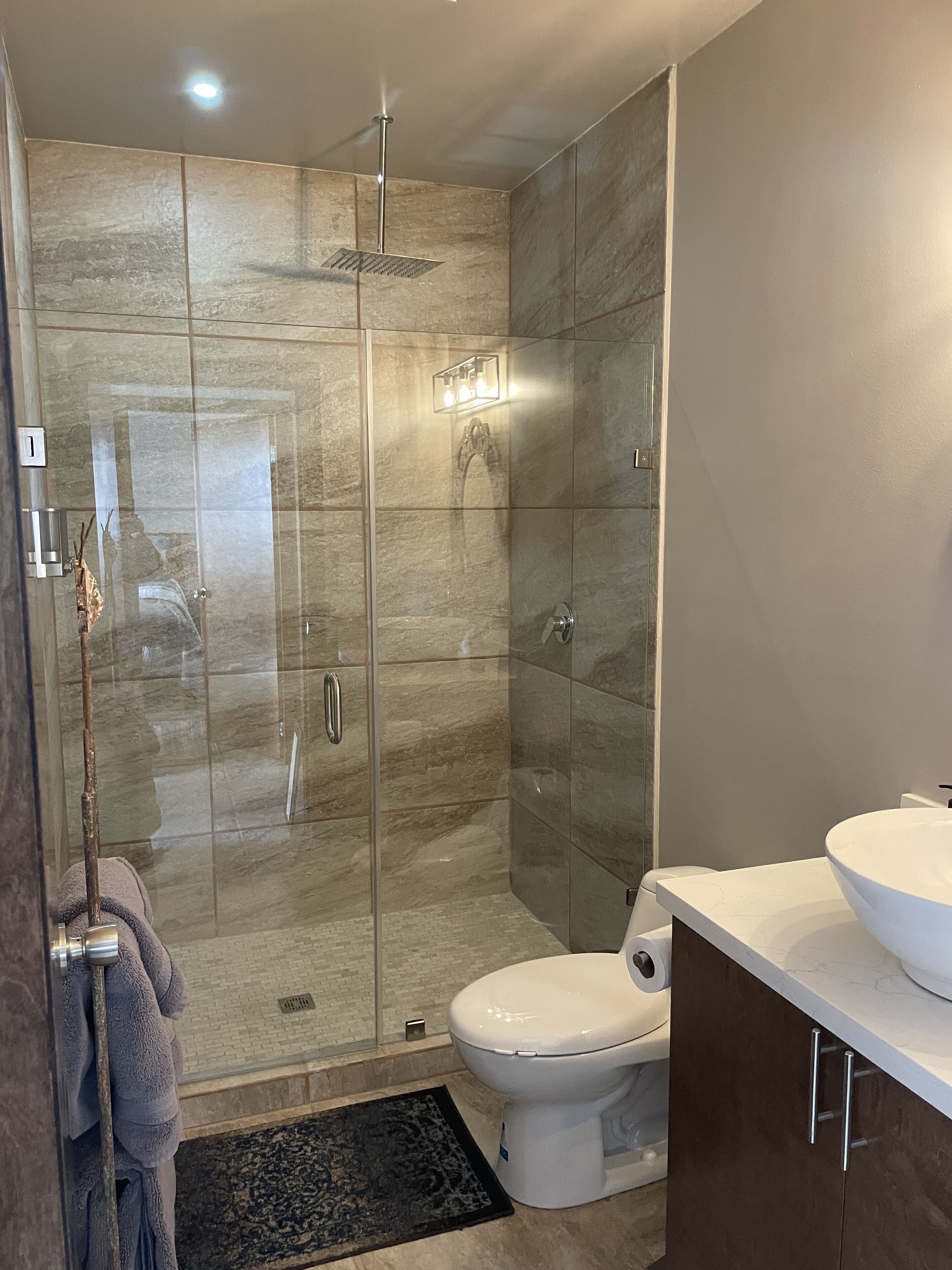 Shower, rainfall showerhead, hair dryer, towels
