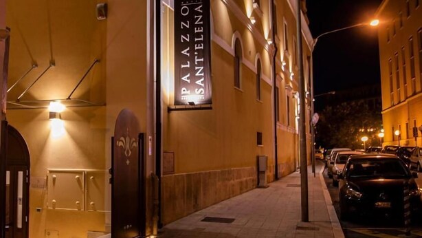 A building with a sign reading "Palazzo Sant'Elena" and a street with parked cars. - Palazzo Sant'Elena (Foggia)