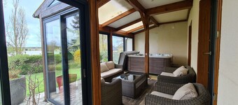 Luxurious Lakeview Retreat: Hot Tub, BBQ, Playground, Near ZooParc & More!