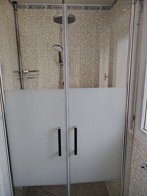 Regadera, secadora de cabello, papel de baño 