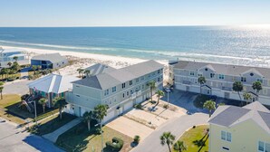 A beachfront residential area with multiple two-story houses, a sandy beach, and the ocean in the background. - Pet Friendly Gulf View Townhome | Sleeps 10 | Game Room (Pensacola Beach)