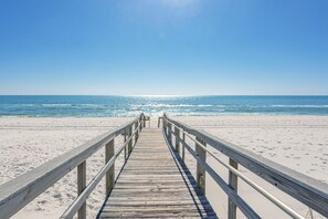 A wooden pier leading to a beach with clear skies. - Pet Friendly Gulf View Townhome | Sleeps 10 | Game Room (Pensacola Beach)