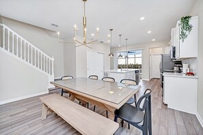 Enjoy meals in the spacious kitchen and dining area, featuring a central island and ample natural light.