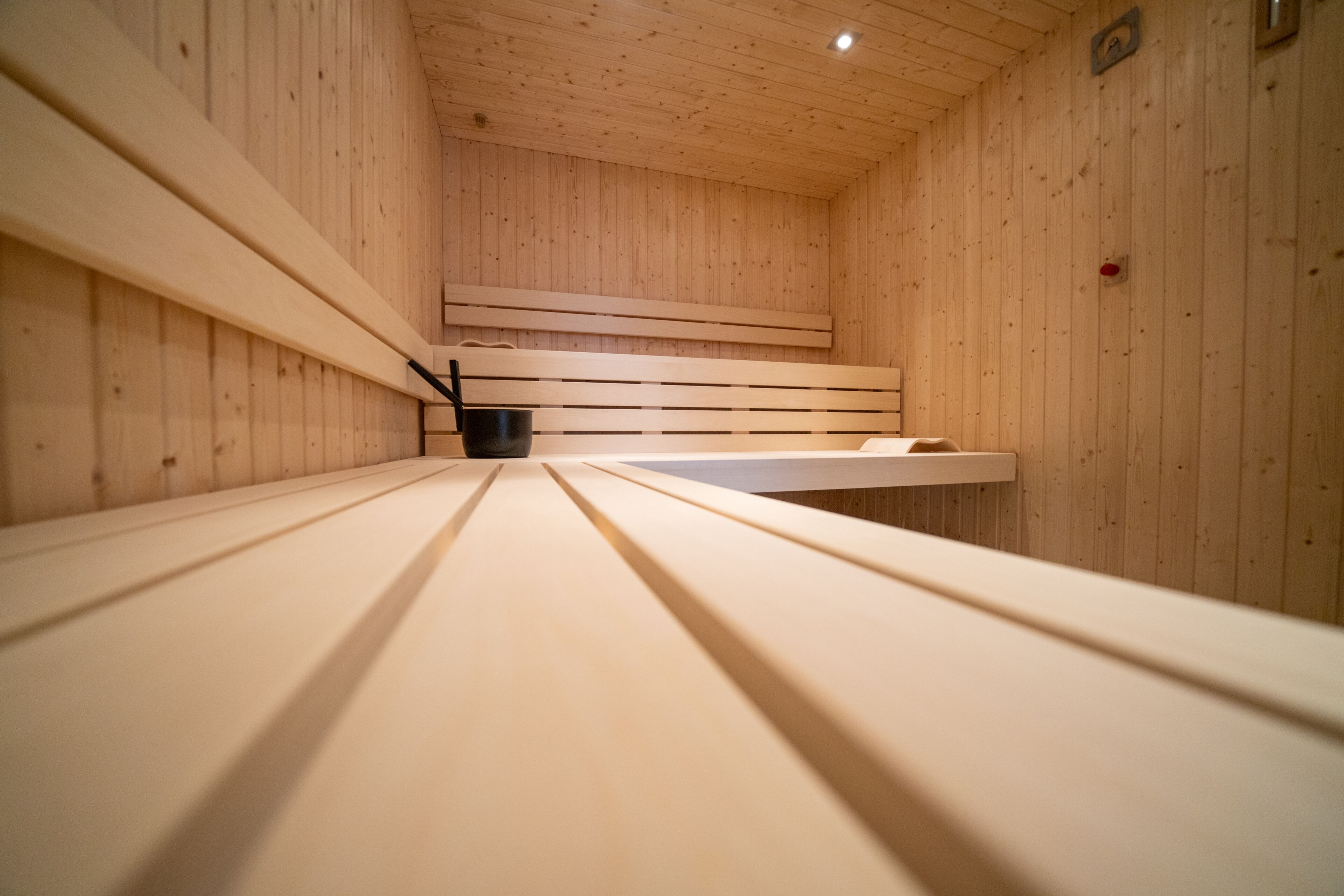 A sauna with wooden benches and a bench seat.
