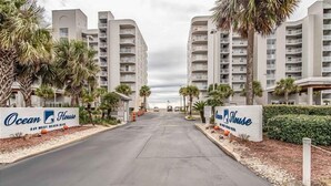A hotel entrance with two Ocean House signs, a paved driveway, and palm trees. - BOOK NOW for a Great GetAway~2 Bedroom/ 3 Bath~Gulf Front!!!! (Gulf Shores)