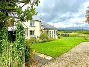 A house with a sign reading "BADGES" and a well-maintained lawn.