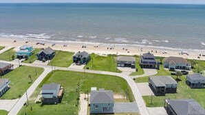 A coastal residential area with houses and a beach.