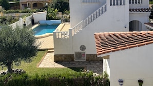 A villa with a swimming pool, a white exterior, and a tiled roof. - Vacation home in Oliva on the Costa Blanca, 10 minutes' walk from the sea. (Oliva Playa)