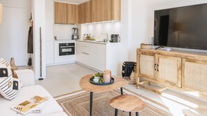 Een modern appartement met keuken, eethoek en zithoek.