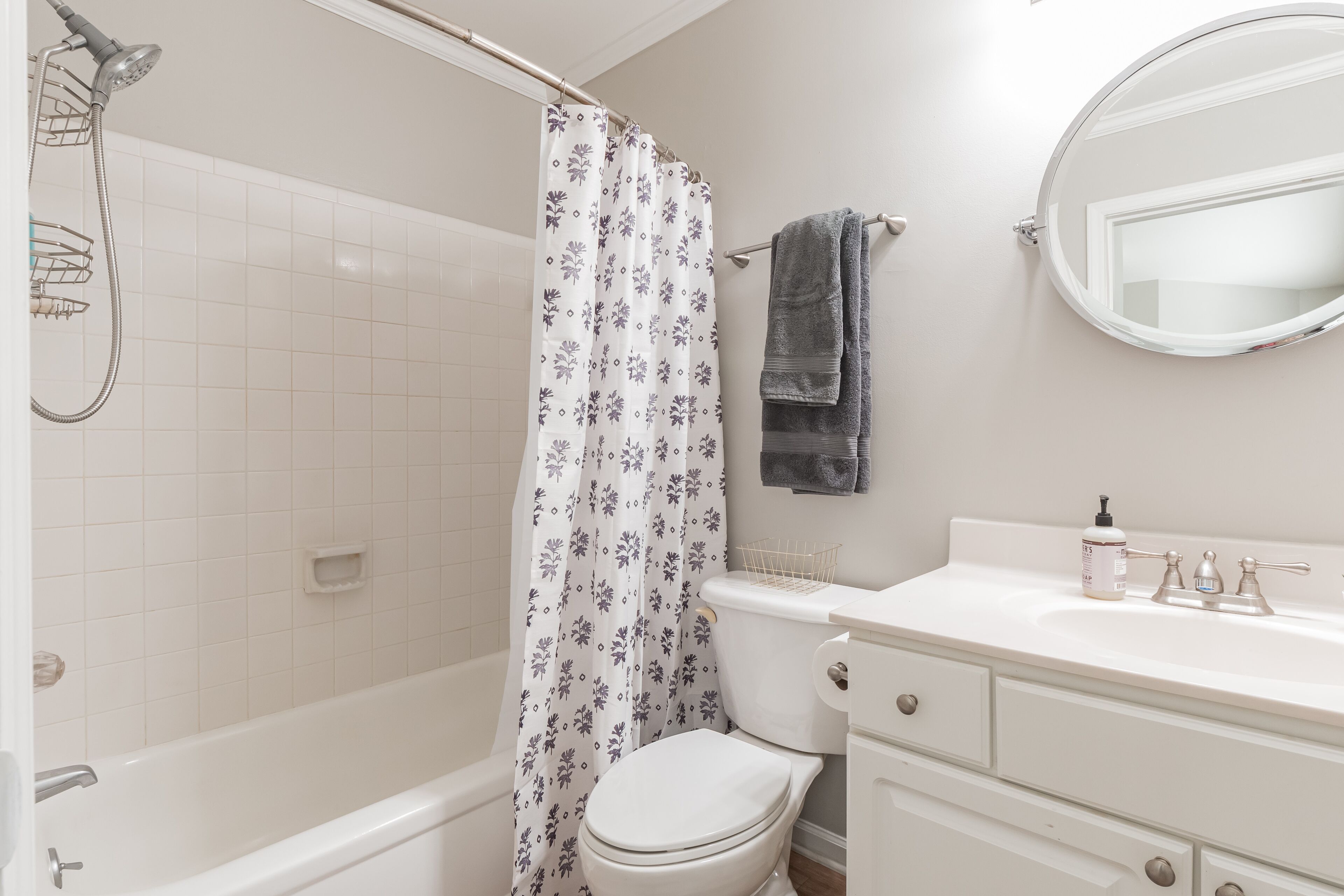 A bathroom with a bathtub, toilet, and sink.