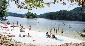Enjoy swimming, sunbathing, and strolling along the lake's shoreline, surrounded by lush greenery and scenic hills.