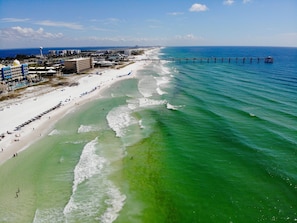 Relax on the beach with ocean views and lounge in comfort under shaded umbrellas.