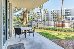 Enjoy a balcony with a round table and four chairs, offering a view of the surrounding residential complex.