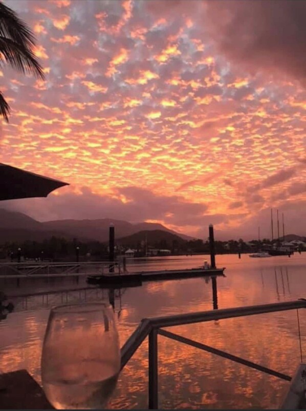 Enjoy waterfront views of calm waters and distant mountains from a serene marina setting.