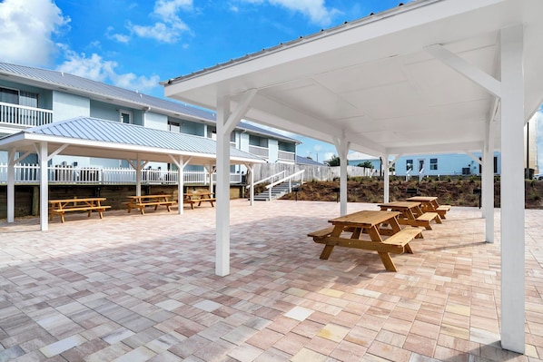 A covered outdoor area with picnic tables and a white pavilion structure. - Beachside Panama City Beach Condo-Steps to Beach & Pool+Amenities (Panama City Beach)