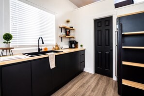 Fridge, microwave, coffee/tea maker, cookware/dishes/utensils