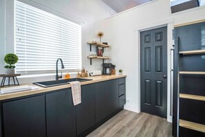 Fridge, microwave, coffee/tea maker, cookware/dishes/utensils