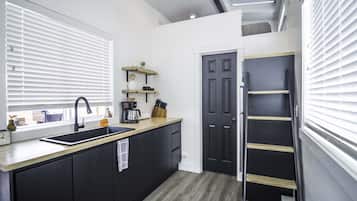 Fridge, microwave, coffee/tea maker, cookware/dishes/utensils