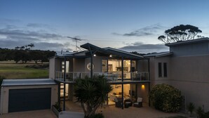 A modern two-story house with a balcony, a garage, and a well-maintained garden. - Shearwaters Appartment (Penneshaw)