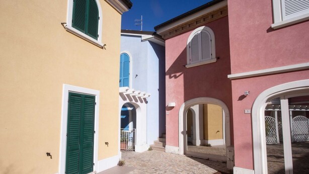 A narrow cobblestone street between buildings with arched doorways and shutters. - M290 - Marcelli, new three-room apartment with terrace (Marcelli)