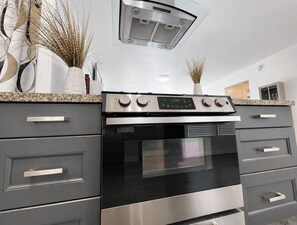 A modern kitchen with a built-in oven and stainless steel appliances. - LA JOLLA SHORES PAD (LA JOLLA)