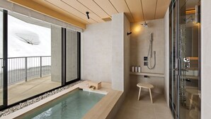 A modern bathroom with a glass-enclosed shower, a bathtub, and a view of a snowy landscape.