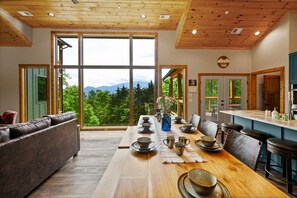 Enjoy a meal at the dining table, relax on the leather sofa, or take in the view from the expansive windows.