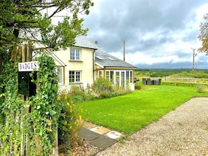 A house with a sign reading "BADGES" and a well-maintained lawn.