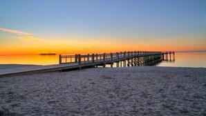 A wooden pier extending into calm waters at sunset. - The Daydreamer - Walk To Walnut Beach, Restaurant + Shops (Milford)