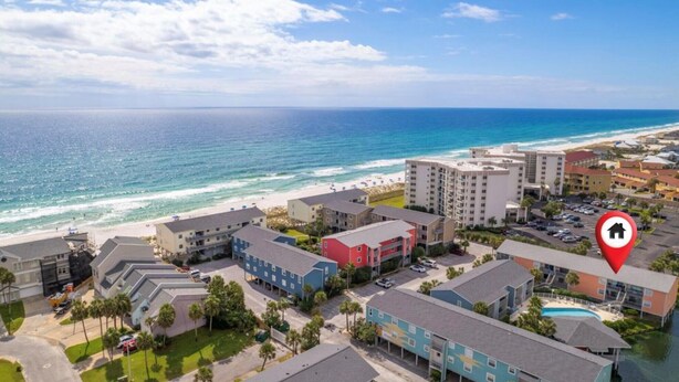 An aerial view of a coastal hotel area with buildings, a beach, and a clear sky. - 2 minutes to the beach (Pensacola Beach)
