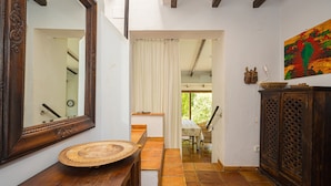 A hallway with a wooden bench, a large mirror, a wooden cabinet, and a painting on the wall. - 'Villa Casa Colina'with Pool and Wi-Fi (Albir)