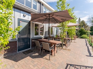 Relax on the patio with comfortable seating and shade under large umbrellas.