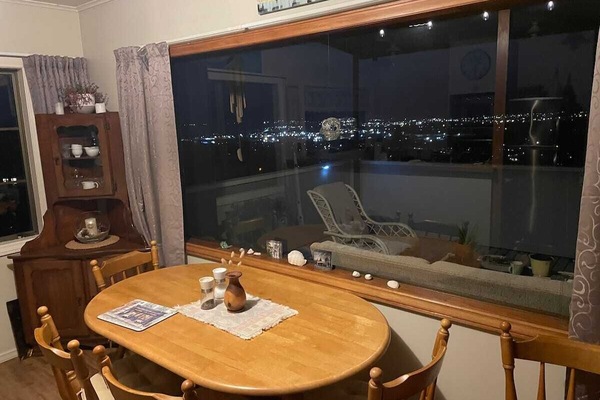 Dining area looking out on deck towards city lights